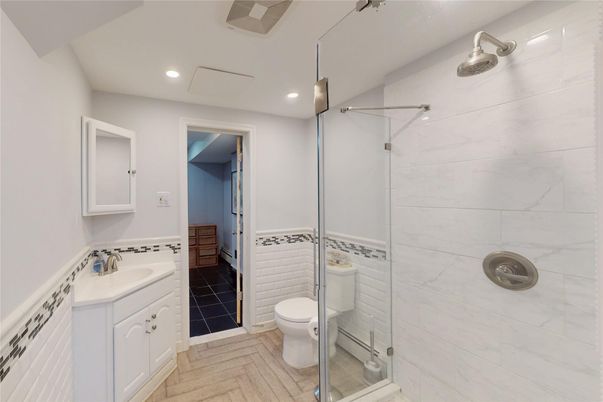 Bathroom, Dual Sink Vanities, Glass Shower, Interior, Marble Walls, Recessed Lighting, Wood Texture Flooring