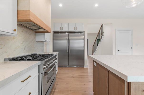 Interior, Kitchen, Marble Walls, Recessed Lighting, Stainless Steel Appliances, Wood Texture Flooring