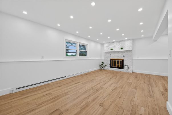Empty room, Fireplace, Interior, Recessed Lighting, Stone Walls, Wood Texture Flooring