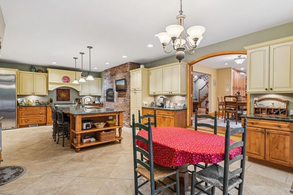 Chandelier, Dining room, Interior, Kitchen, Pendant Lights, Recessed Lighting, Stainless Steel Appliances, Stone Walls