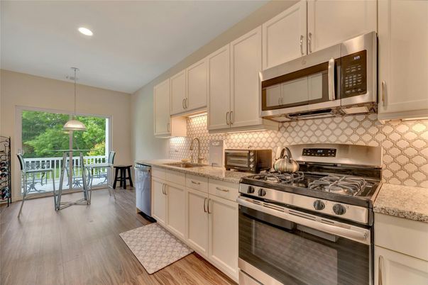 Dining room, Interior, Kitchen, Pendant Lights, Recessed Lighting, Stainless Steel Appliances, Wood Texture Flooring
