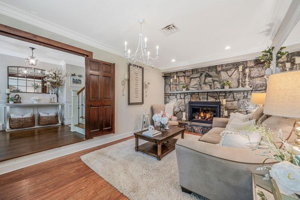 Chandelier, Fireplace, Interior, Living room, Recessed Lighting, Stone Walls, Wood Texture Flooring