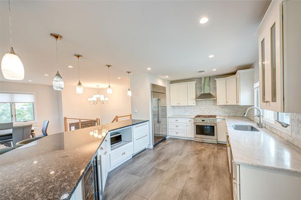 Dining room, Interior, Kitchen, Pendant Lights, Recessed Lighting, Stainless Steel Appliances, Wood Texture Flooring
