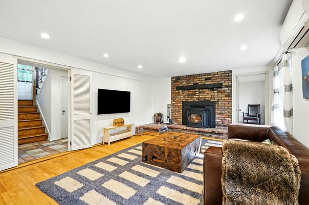 Fireplace, Interior, Living room, Recessed Lighting, Stone Walls, Wood Texture Flooring