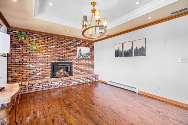 Chandelier, Empty room, Fireplace, Interior, Recessed Lighting, Stone Walls, Wood Texture Flooring