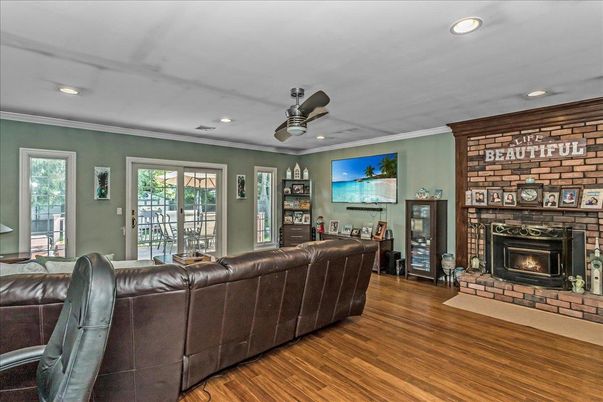 Fireplace, Interior, Living room, Recessed Lighting, Stone Walls, Wood Texture Flooring