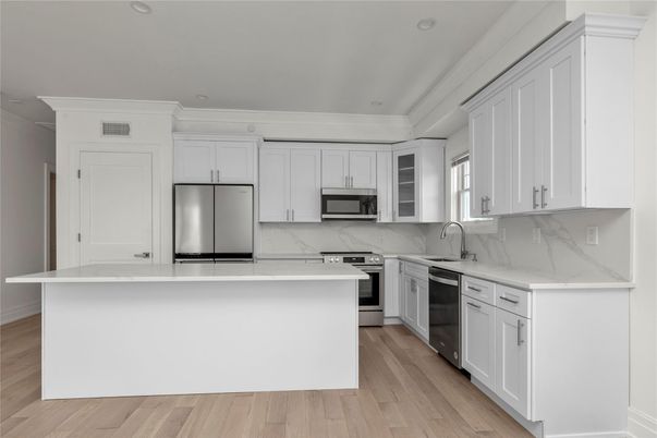 Interior, Kitchen, Marble Walls, Recessed Lighting, Stainless Steel Appliances, Wood Texture Flooring