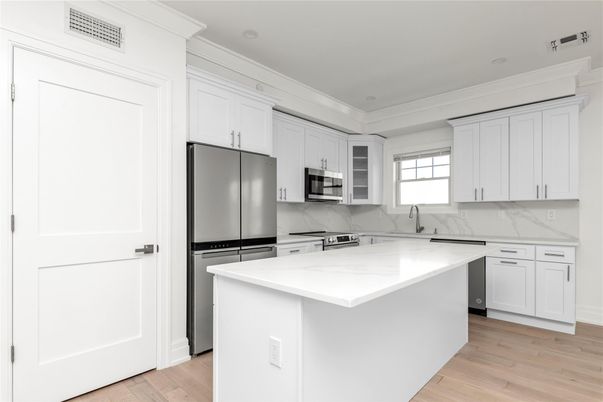 Interior, Kitchen, Marble Walls, Recessed Lighting, Stainless Steel Appliances, Wood Texture Flooring