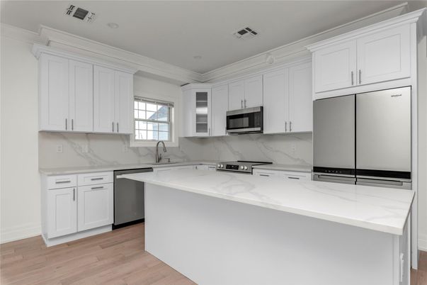 Interior, Kitchen, Marble Walls, Recessed Lighting, Stainless Steel Appliances, Wood Texture Flooring