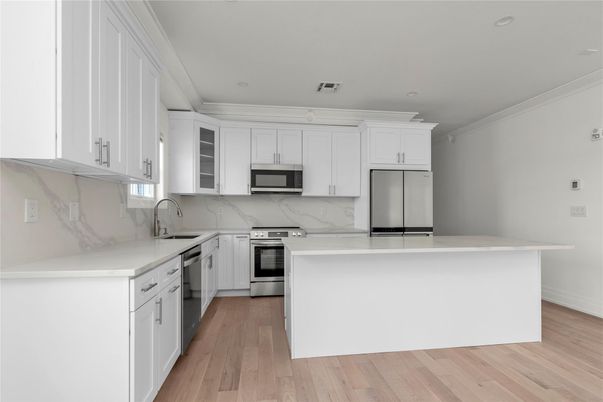 Interior, Kitchen, Marble Walls, Recessed Lighting, Stainless Steel Appliances, Wood Texture Flooring
