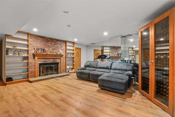 Fireplace, Fitness Equipment, Interior, Living room, Recessed Lighting, Stone Walls, Wood Texture Flooring