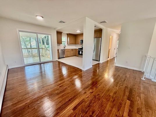 Empty room, Interior, Kitchen, Recessed Lighting, Stainless Steel Appliances, Wood Texture Flooring