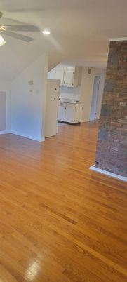 Empty room, Fireplace, Interior, Kitchen, Recessed Lighting, Stone Walls, Wood Texture Flooring