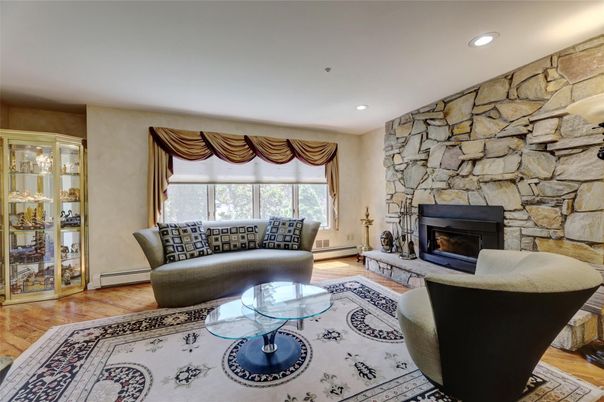 Fireplace, Interior, Living room, Recessed Lighting, Stone Walls, Wood Texture Flooring