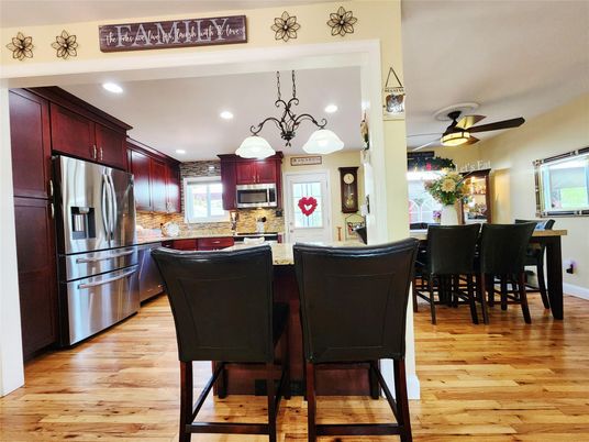 Chandelier, Dining room, Interior, Kitchen, Recessed Lighting, Stainless Steel Appliances, Wood Texture Flooring