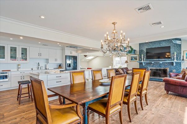 Chandelier, Dining room, Fireplace, Interior, Kitchen, Living room, Recessed Lighting, Stainless Steel Appliances, Wood Texture Flooring