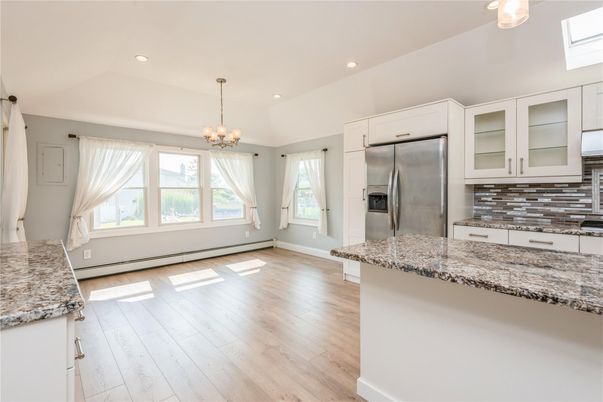 Chandelier, Empty room, Interior, Kitchen, Pendant Lights, Recessed Lighting, Stainless Steel Appliances, Wood Texture Flooring