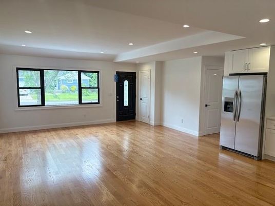 Empty room, Interior, Kitchen, Recessed Lighting, Stainless Steel Appliances, Wood Texture Flooring