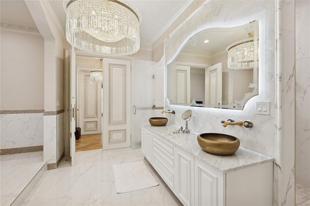 Bathroom, Chandelier, Dual Sink Vanities, Interior, Marble, Marble Walls, Recessed Lighting, Wood Texture Flooring