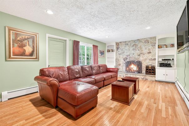 Fireplace, Interior, Living room, Recessed Lighting, Stone Walls, Wood Texture Flooring