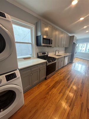 Interior, Kitchen, Recessed Lighting, Washer, Wood Texture Flooring