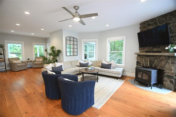 Fireplace, Interior, Living room, Recessed Lighting, Stone Walls, Wood Texture Flooring