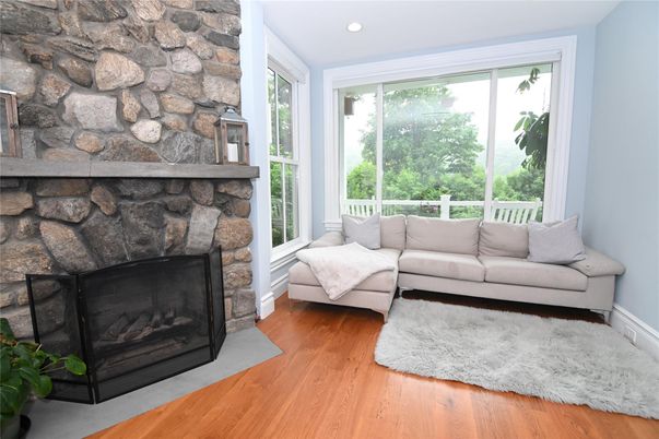 Fireplace, Interior, Living room, Recessed Lighting, Stone Walls, Wood Texture Flooring