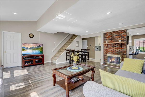 Dining room, Fireplace, Interior, Living room, Recessed Lighting, Stone Walls, Wood Texture Flooring