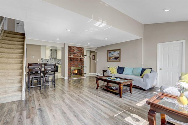 Dining room, Fireplace, Interior, Living room, Recessed Lighting, Stone Walls, Wood Texture Flooring