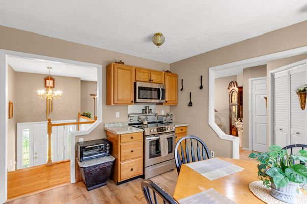 Chandelier, Dining room, Interior, Kitchen, Pendant Lights, Stainless Steel Appliances, Wood Texture Flooring