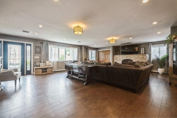 Fireplace, Game Room, Interior, Living room, Recessed Lighting, Wood Texture Flooring
