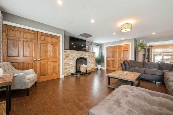 Fireplace, Interior, Living room, Recessed Lighting, Stone Walls, Wood Texture Flooring