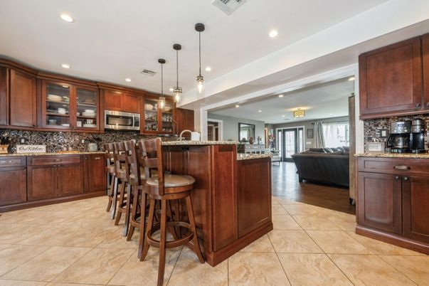 Chandelier, Interior, Kitchen, Living room, Pendant Lights, Recessed Lighting, Stainless Steel Appliances, Wood Texture Flooring