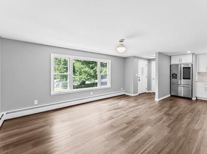 Empty room, Interior, Kitchen, Recessed Lighting, Stainless Steel Appliances, Wood Texture Flooring