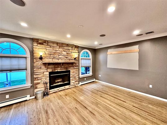 Empty room, Fireplace, Interior, Recessed Lighting, Stone Walls, Wood Texture Flooring