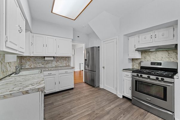 Interior, Kitchen, Marble Walls, Recessed Lighting, Stainless Steel Appliances, Wood Texture Flooring