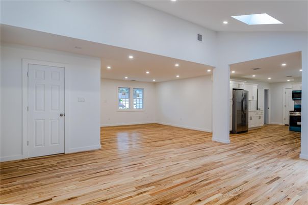 Empty room, Interior, Kitchen, Recessed Lighting, Stainless Steel Appliances, Wood Texture Flooring