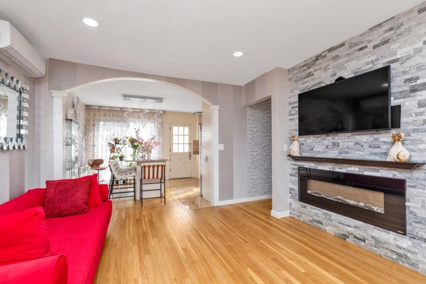 Dining room, Fireplace, Interior, Living room, Recessed Lighting, Stone Walls, Wood Texture Flooring