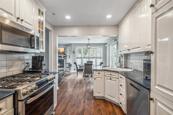 Dining room, Fireplace, Interior, Kitchen, Pendant Lights, Recessed Lighting, Stainless Steel Appliances, Wood Texture Flooring