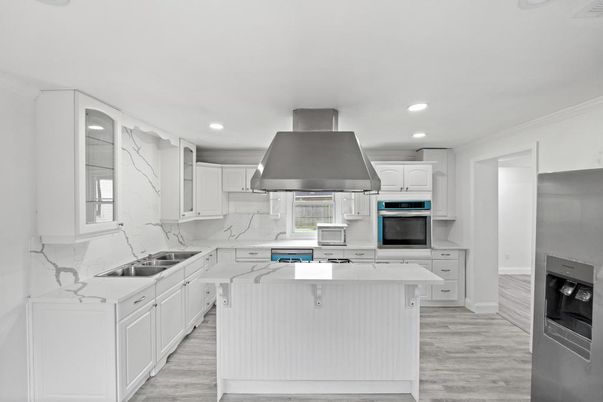 Interior, Kitchen, Marble Walls, Recessed Lighting, Stainless Steel Appliances, Wood Texture Flooring