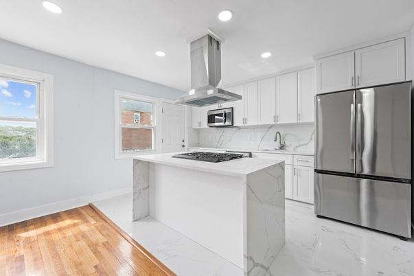 Interior, Kitchen, Marble, Marble Walls, Recessed Lighting, Stainless Steel Appliances, Wood Texture Flooring
