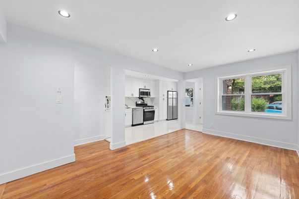 Empty room, Interior, Kitchen, Recessed Lighting, Stainless Steel Appliances, Wood Texture Flooring