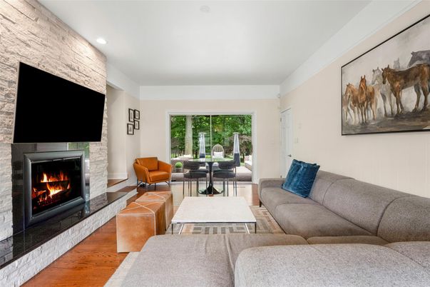 Fireplace, Interior, Living room, Recessed Lighting, Stone Walls, Wood Texture Flooring