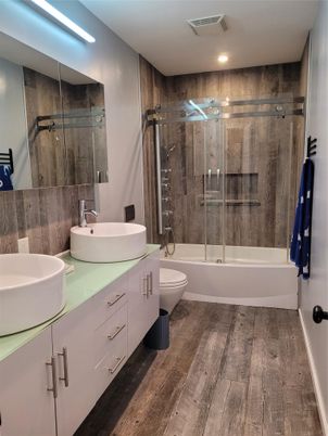 Bathroom, Dual Sink Vanities, Glass Shower, Interior, Recessed Lighting, Wood Texture Flooring