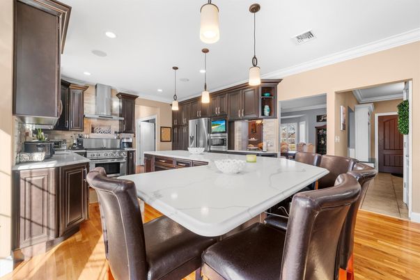 Dining room, Interior, Kitchen, Pendant Lights, Recessed Lighting, Stainless Steel Appliances, Wood Texture Flooring