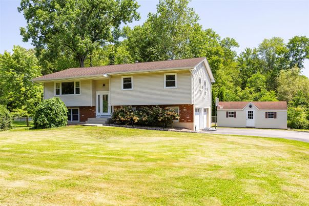 Attached, Backyard, Exterior, Facade, Brick Facade, Raised Ranch