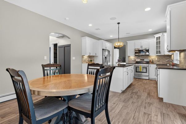 Dining room, Interior, Kitchen, Pendant Lights, Recessed Lighting, Stainless Steel Appliances, Wood Texture Flooring