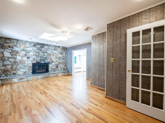Empty room, Fireplace, Interior, Recessed Lighting, Stone Walls, Wood Texture Flooring