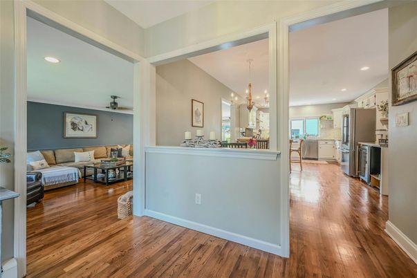 Chandelier, Dining room, Interior, Kitchen, Living room, Pendant Lights, Recessed Lighting, Stainless Steel Appliances, Wood Texture Flooring