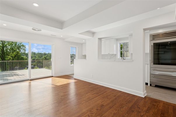 Empty room, Interior, Kitchen, Recessed Lighting, Stainless Steel Appliances, Wood Texture Flooring